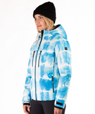 Woman wearing a blue and white tie-died pattern jacket on a white background