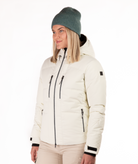 Woman wearing a black quilted winter jacket on a white background