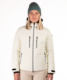Woman wearing a white quilted winter jacket on a white background
