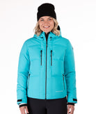 Person wearing a bright blue quilted winter jacket on a white background