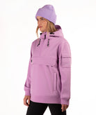 A woman wearing a light purple/lavender hooded jacket and matching ribbed knit beanie, shown in profile against a plain white studio background.