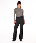 Person wearing black rip stop patterned pants with white thread pants on a white background