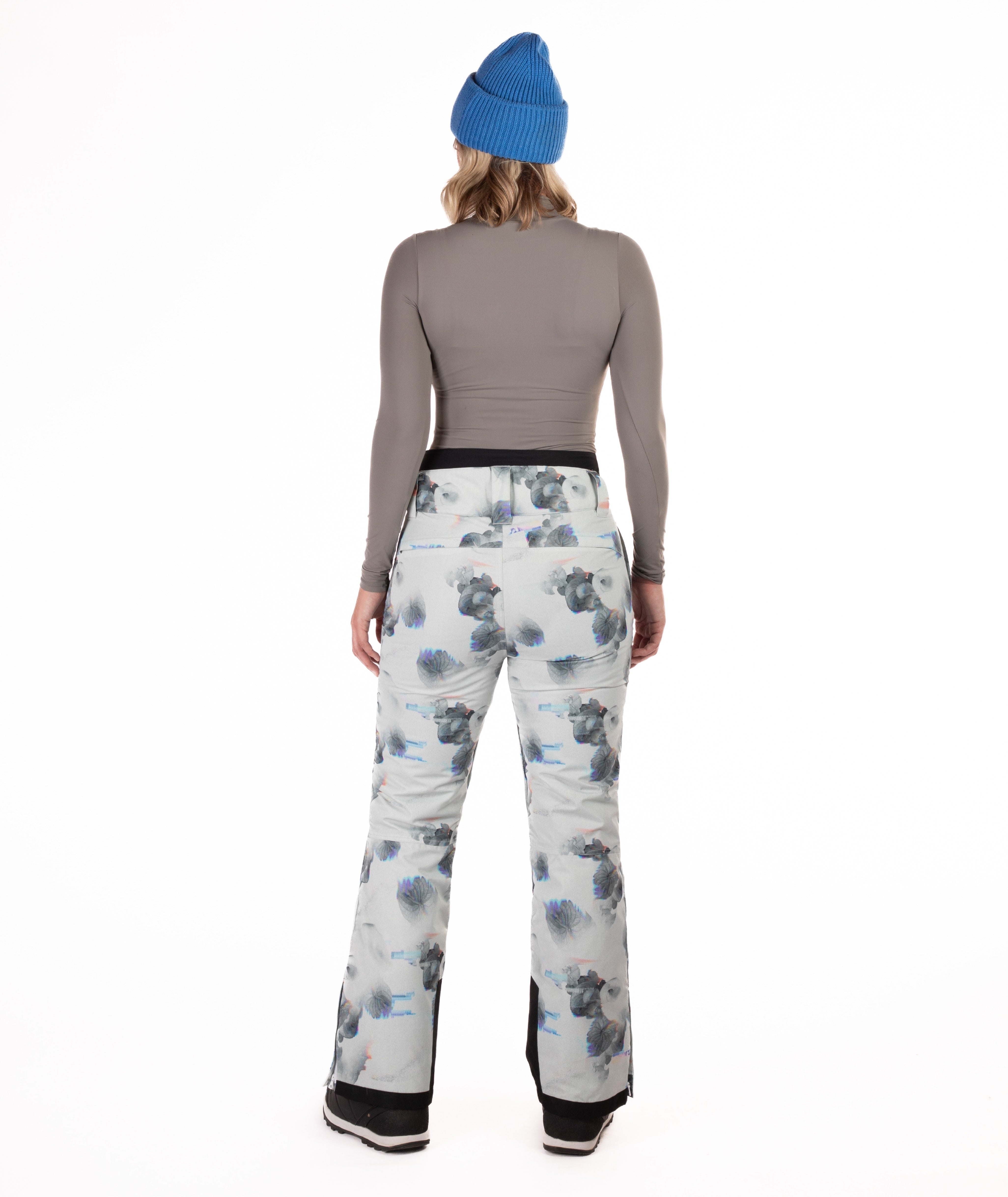 back of Person wearing floral patterned pants on a white background