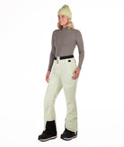 Person wearing light green pants on a white background