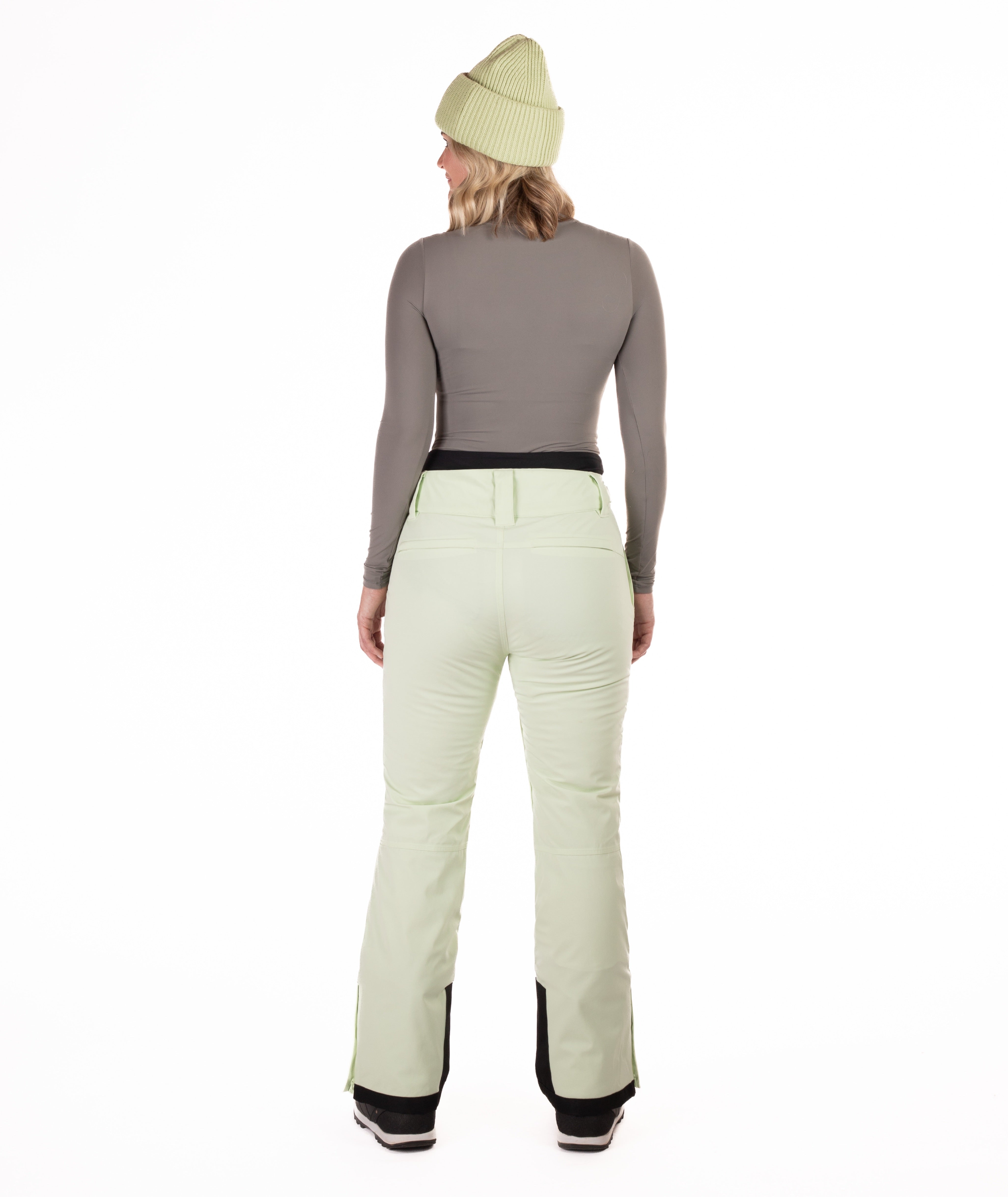 back of Person wearing light green pants on a white background