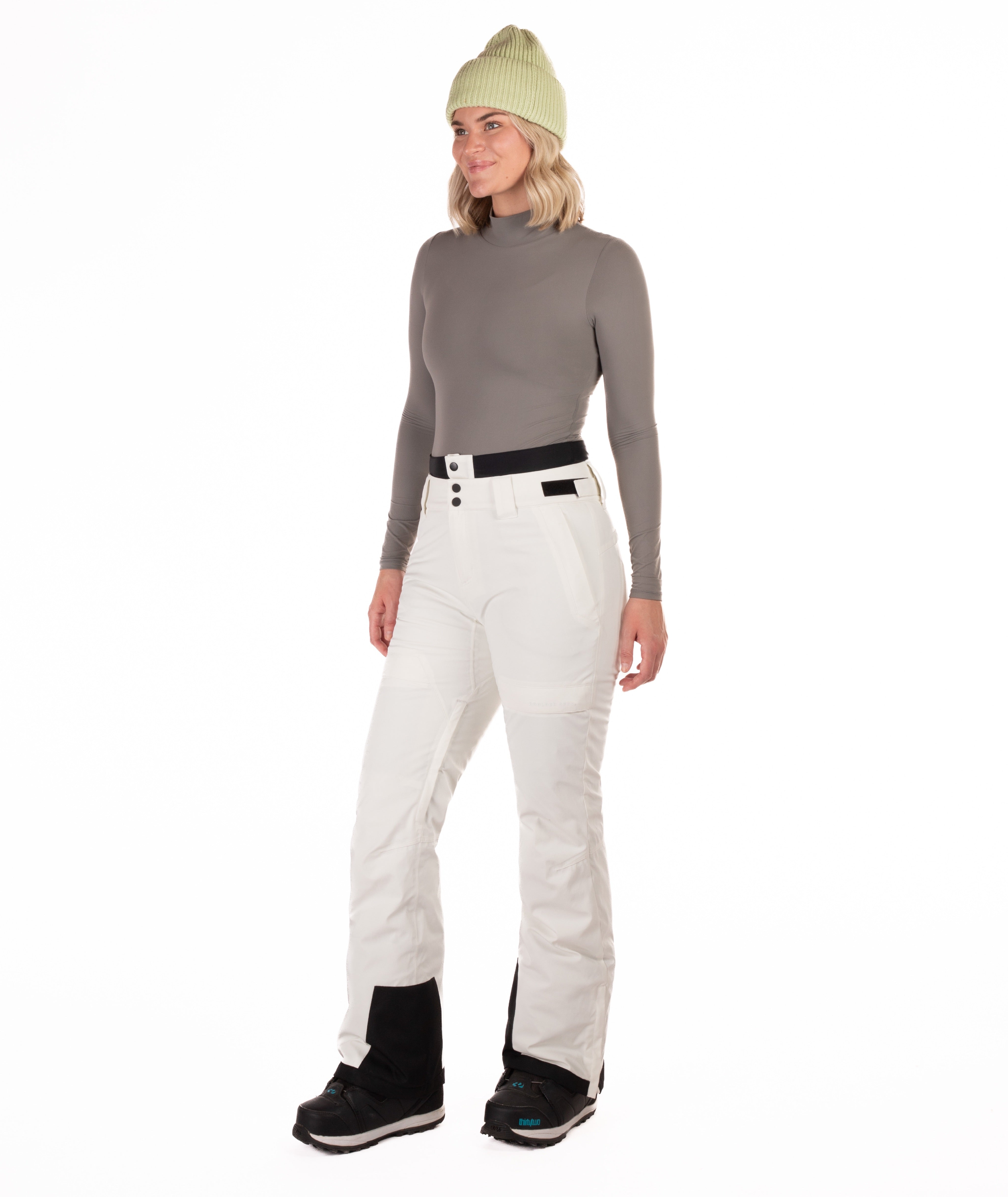 Person wearing off white colored pants on a white background