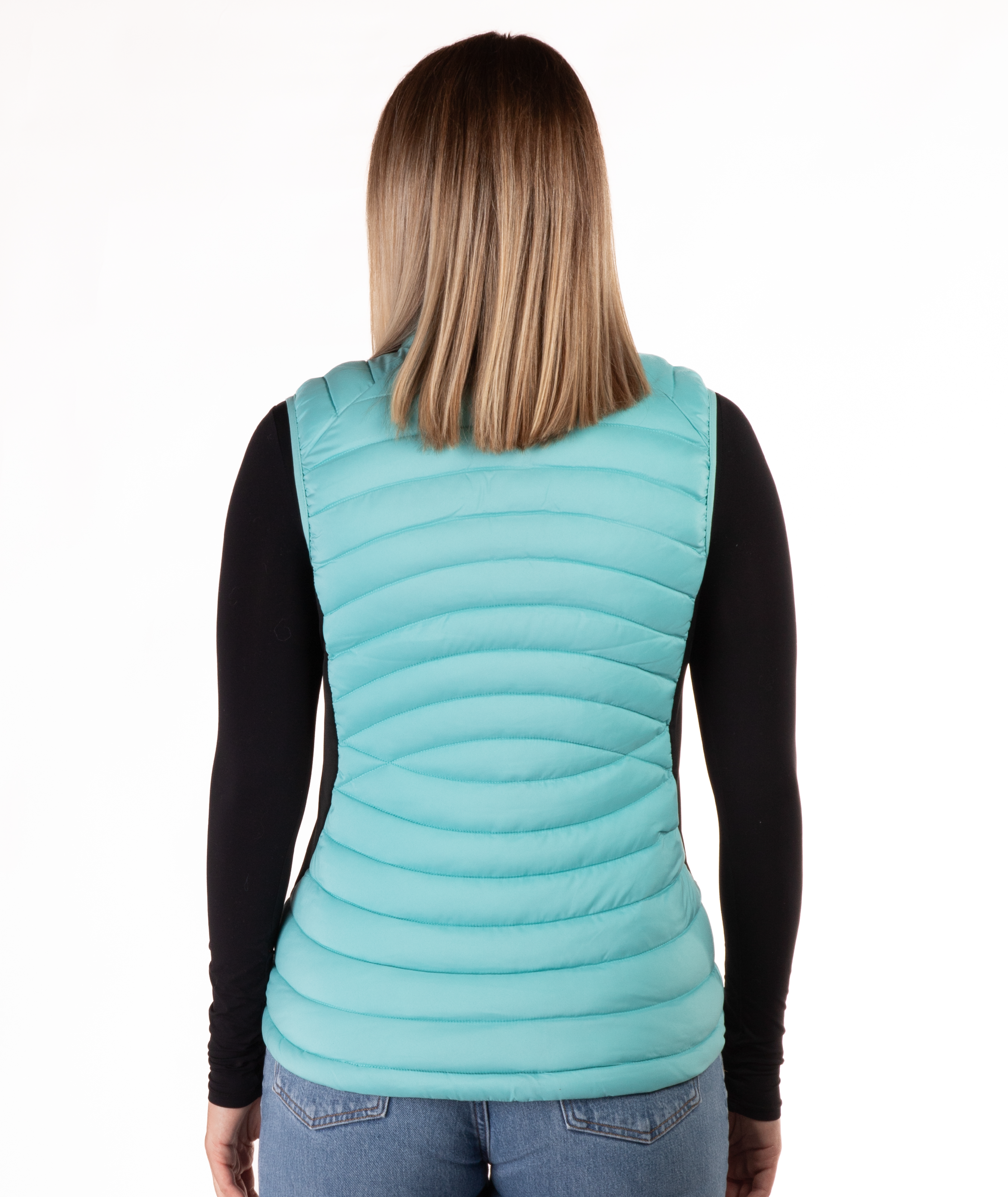 back of woman wearing a turquoise puffer vest over a black long-sleeve shirt on a white background