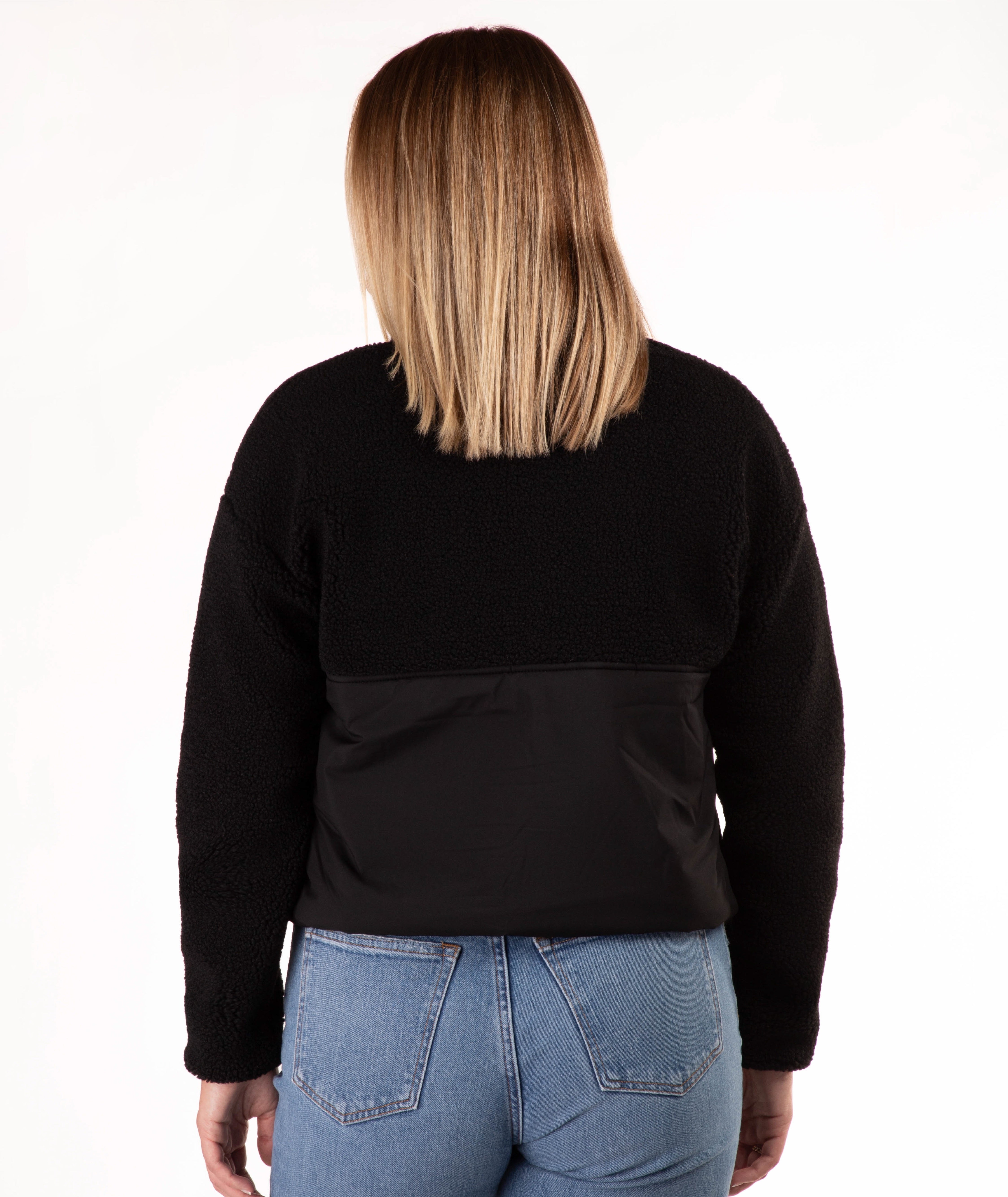 back of Woman wearing a black fleece jacket on a white background