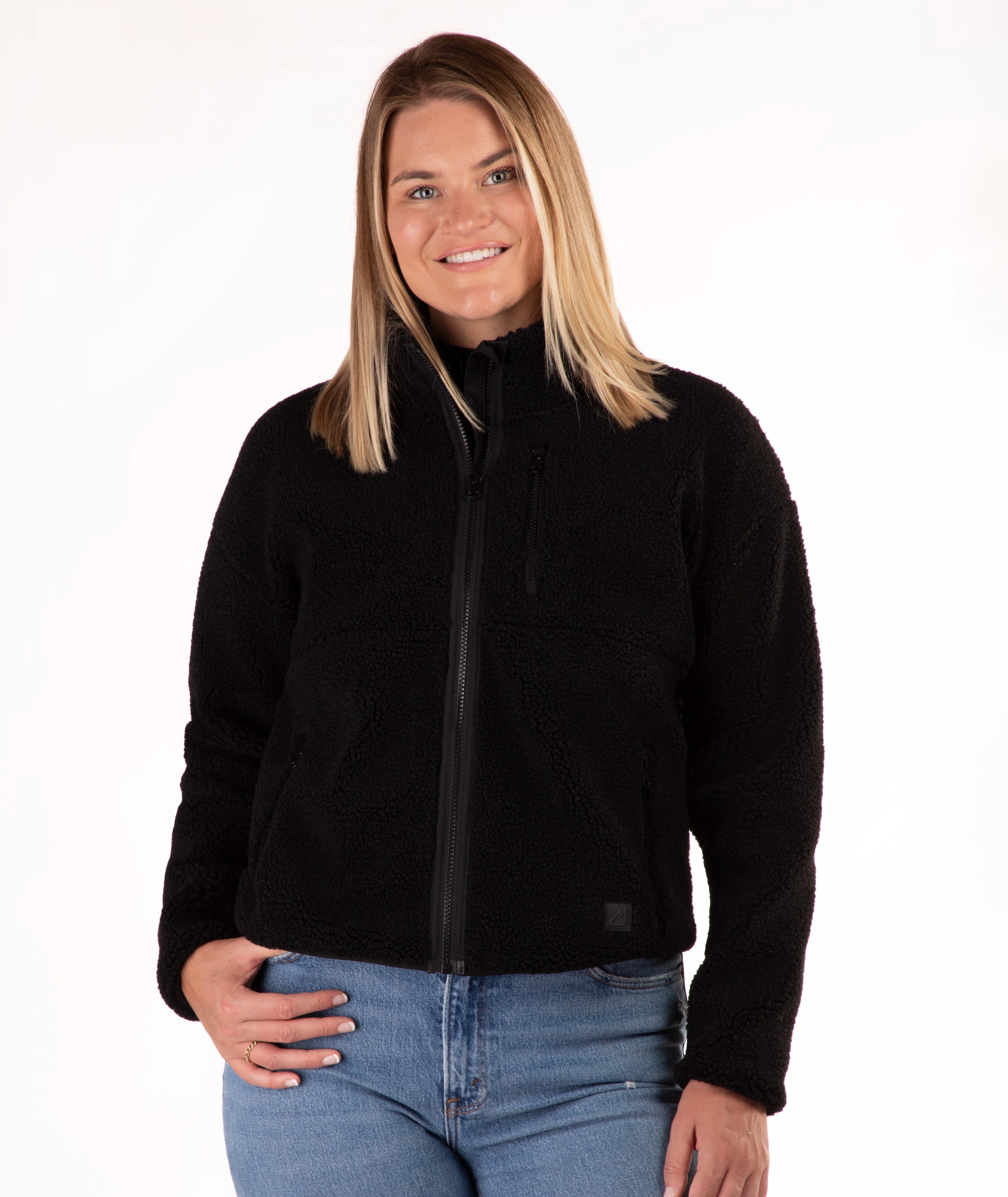 Woman wearing a black fleece jacket on a white background