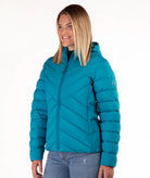 A woman wearing a teal blue hooded puffer jacket with a full-zip front, shown from the waist up against a plain white background.