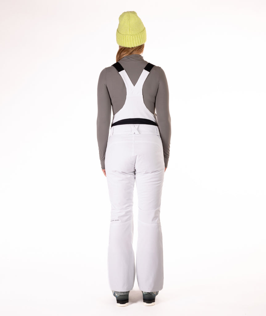Back of person wearing a white snow bib overalls on a white background.
