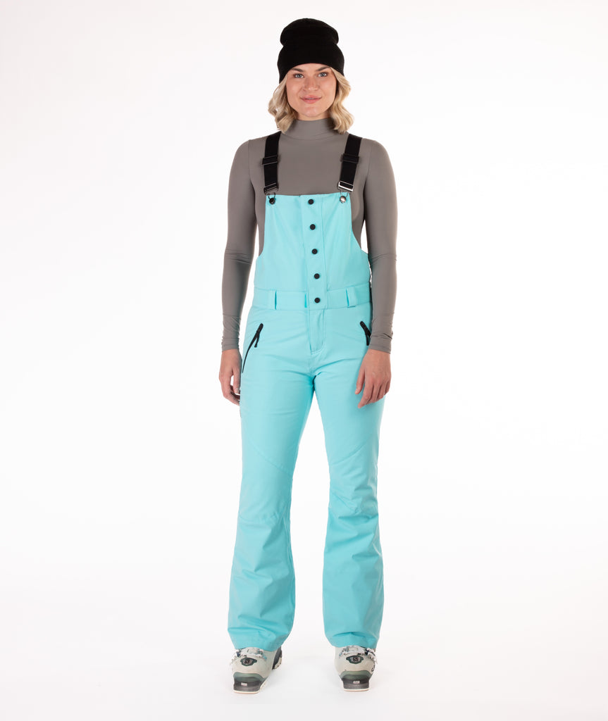 Person wearing a light blue snow bib overalls on a white background.