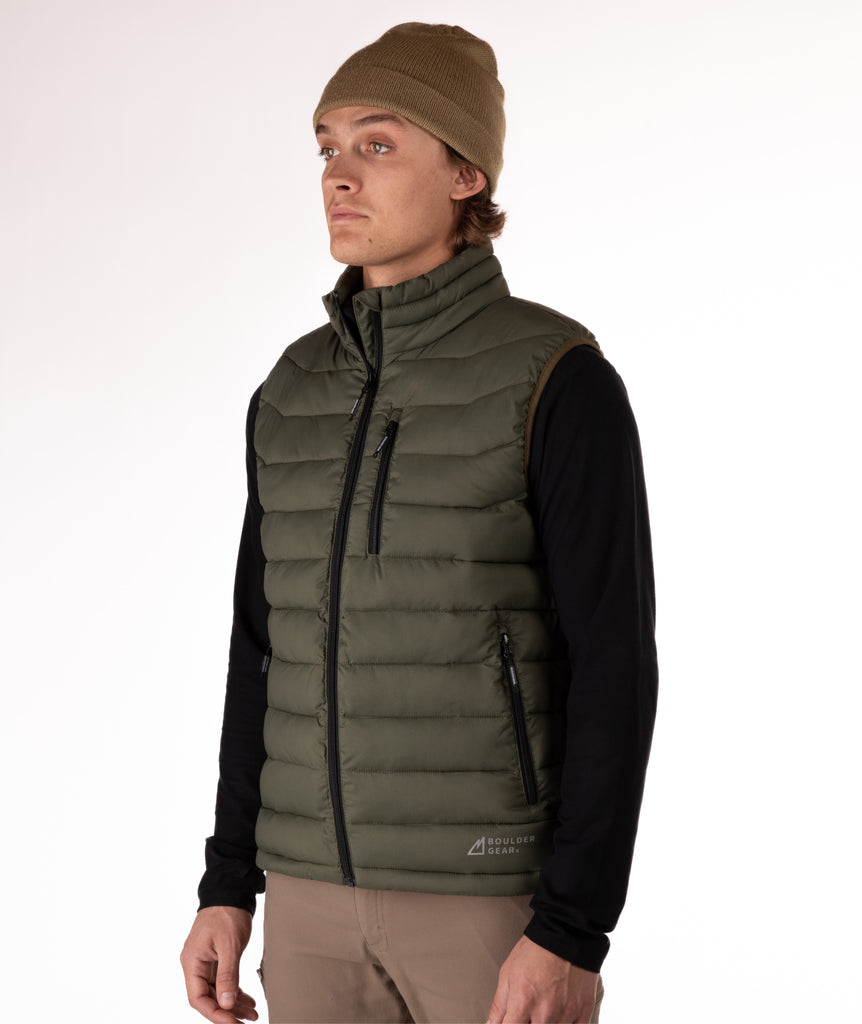 Man wearing a green puffer vest over a black shirt on a white background