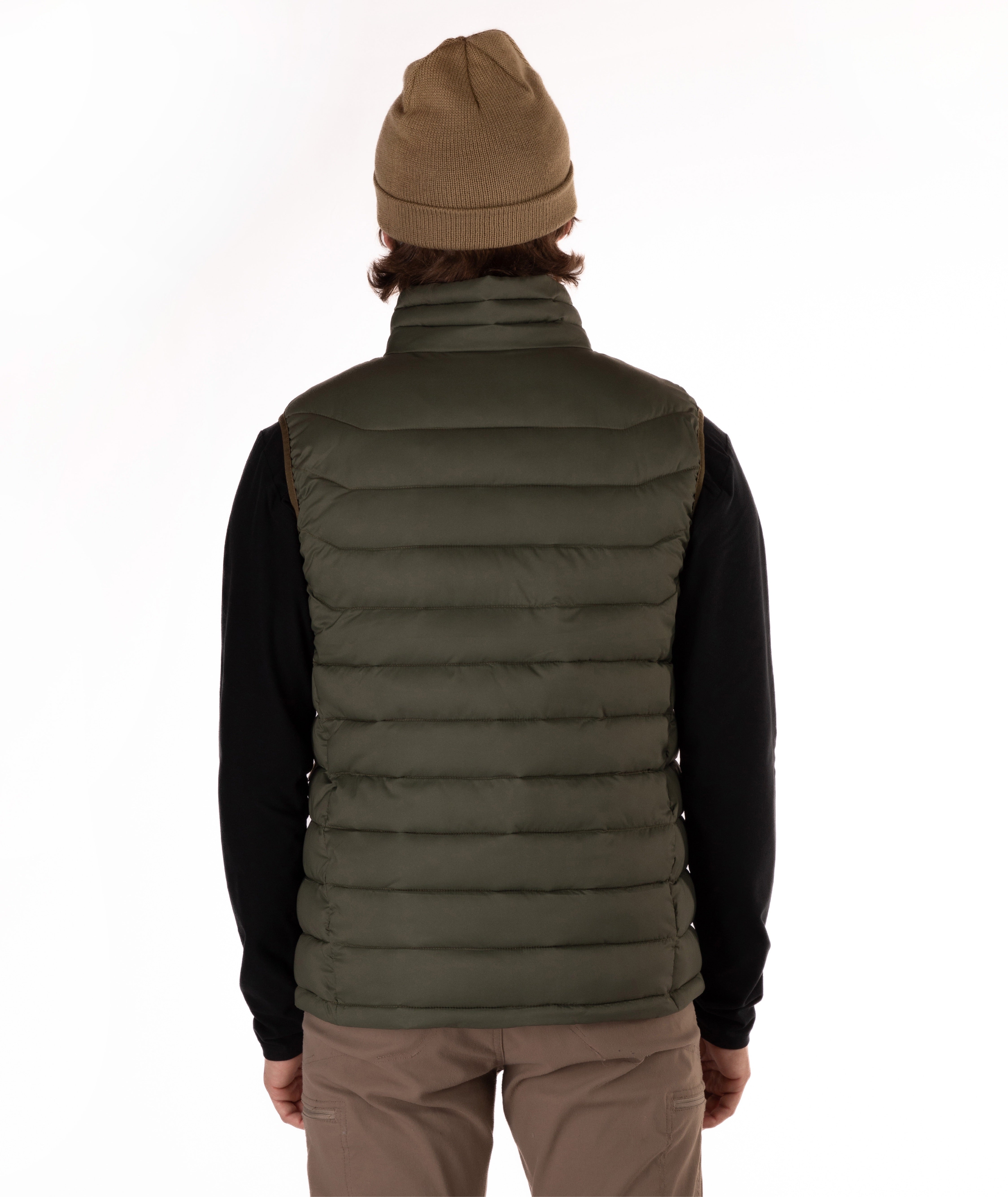 A person shown from the back wearing an olive green puffer vest over a black long-sleeve shirt, with a tan beanie and tan pants, against a plain white studio background.