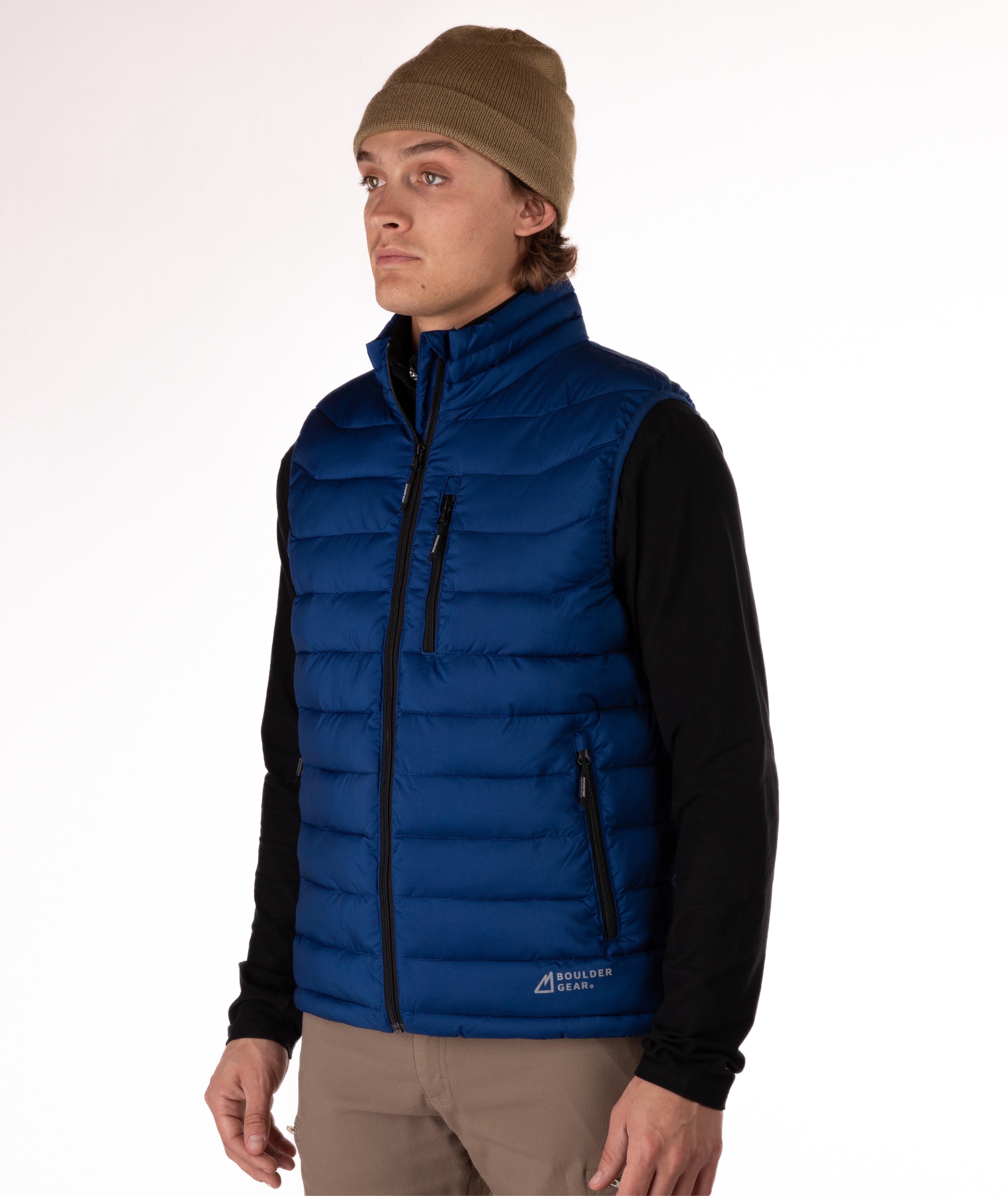 Man wearing a navy blue puffer vest over a black shirt on a white background