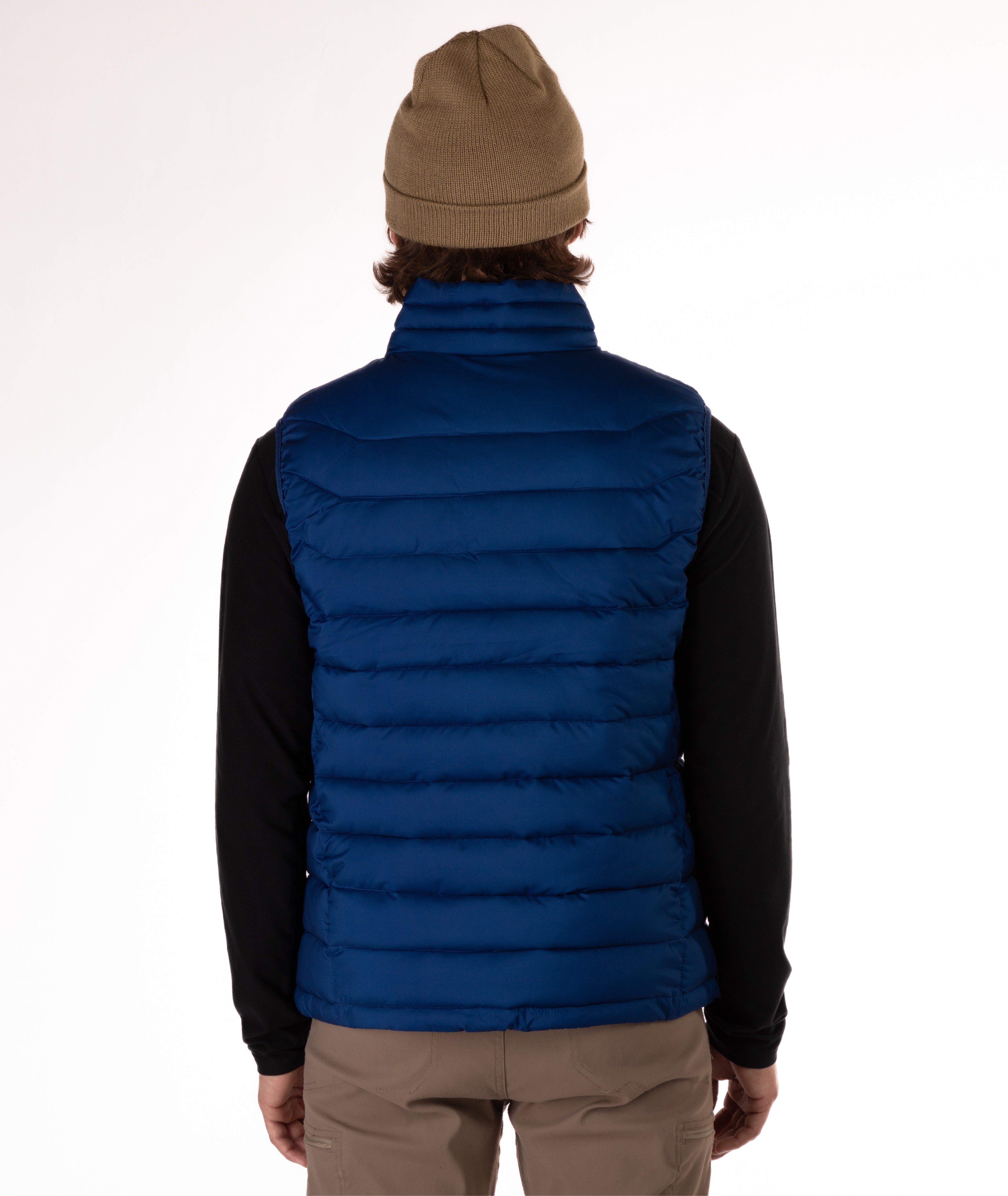 back of Man wearing a navy blue puffer vest over a black shirt on a white background