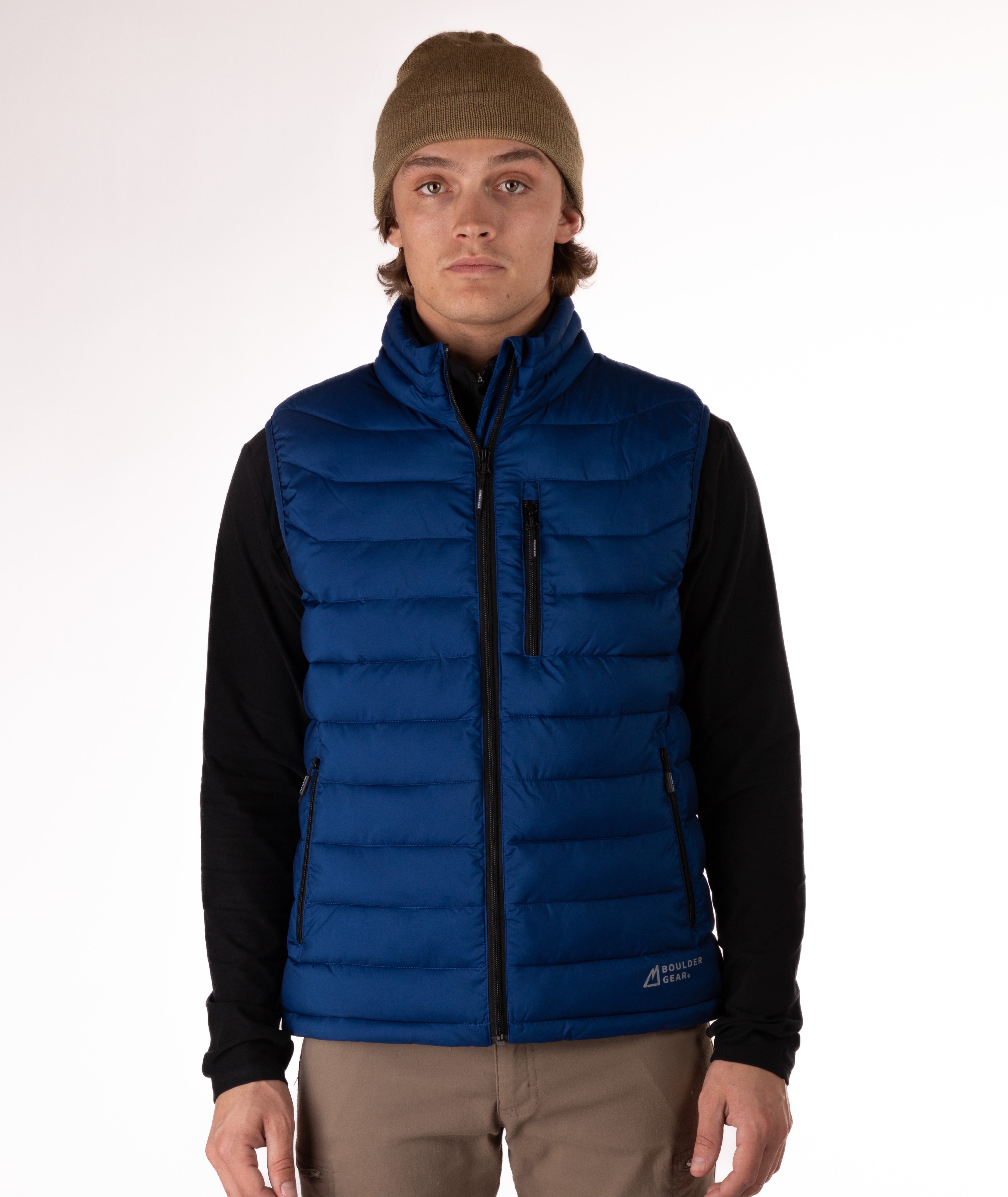 Man wearing a navy blue puffer vest over a black shirt on a white background