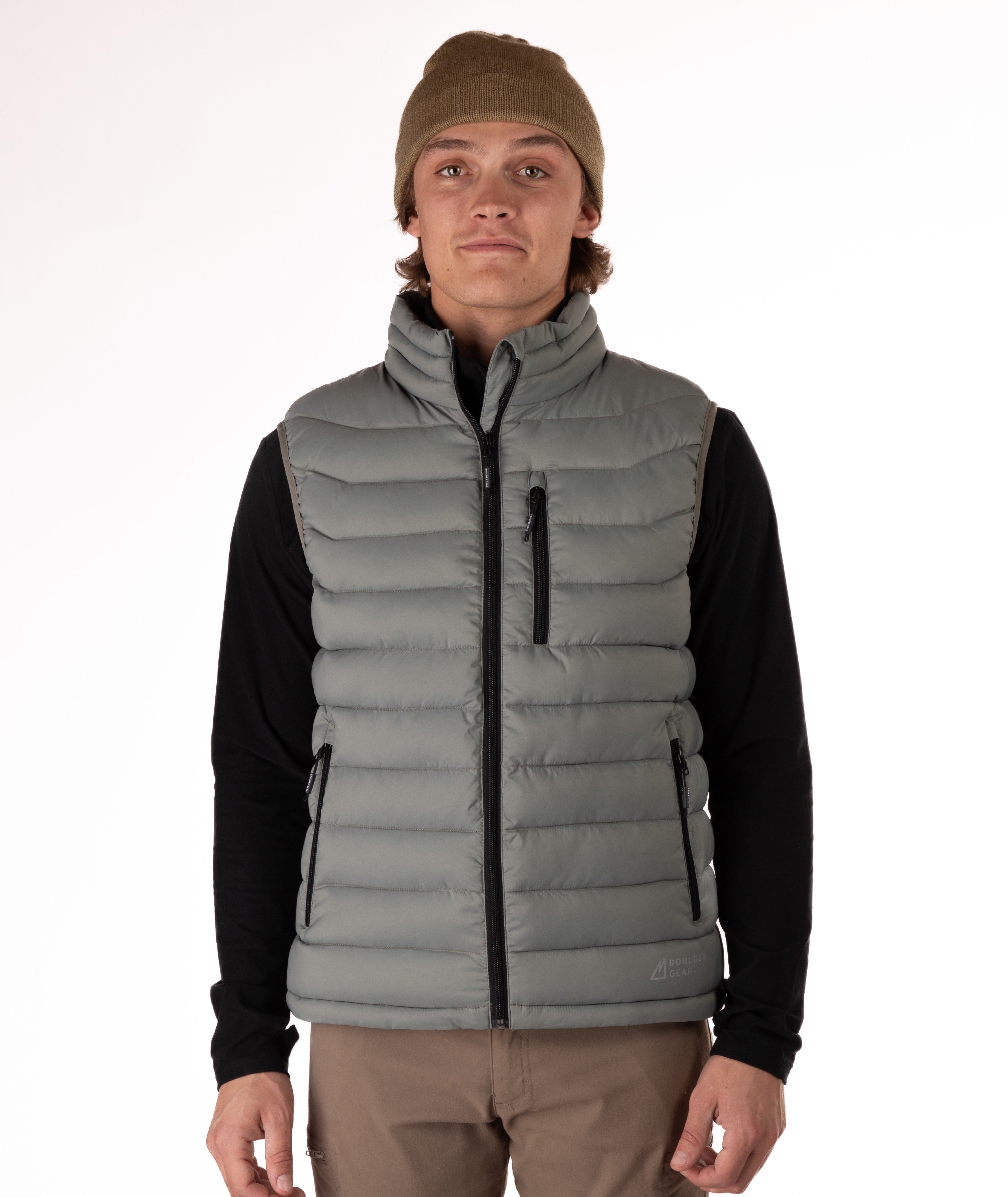 Man wearing a beige puffer vest over a black shirt on a white background