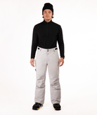 Person wearing a black top and light gray snow pants on a white background