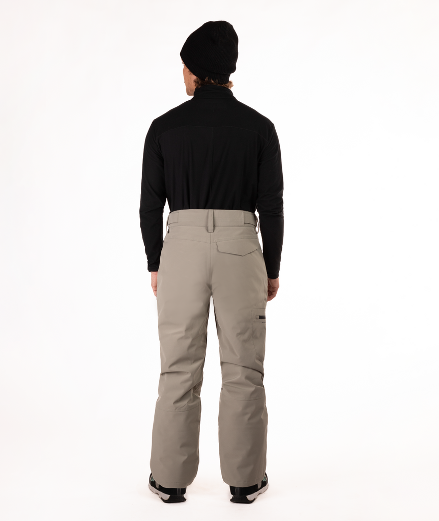 back of Person wearing a black top and beige snow pants on a white background