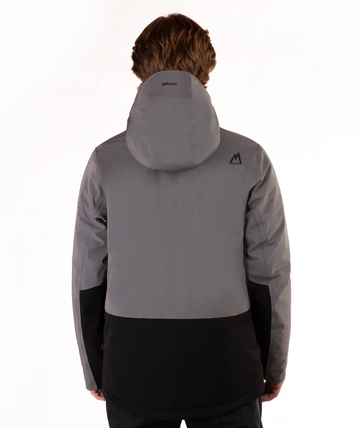 A person shown from the back wearing a gray and black hooded jacket against a plain white studio background.