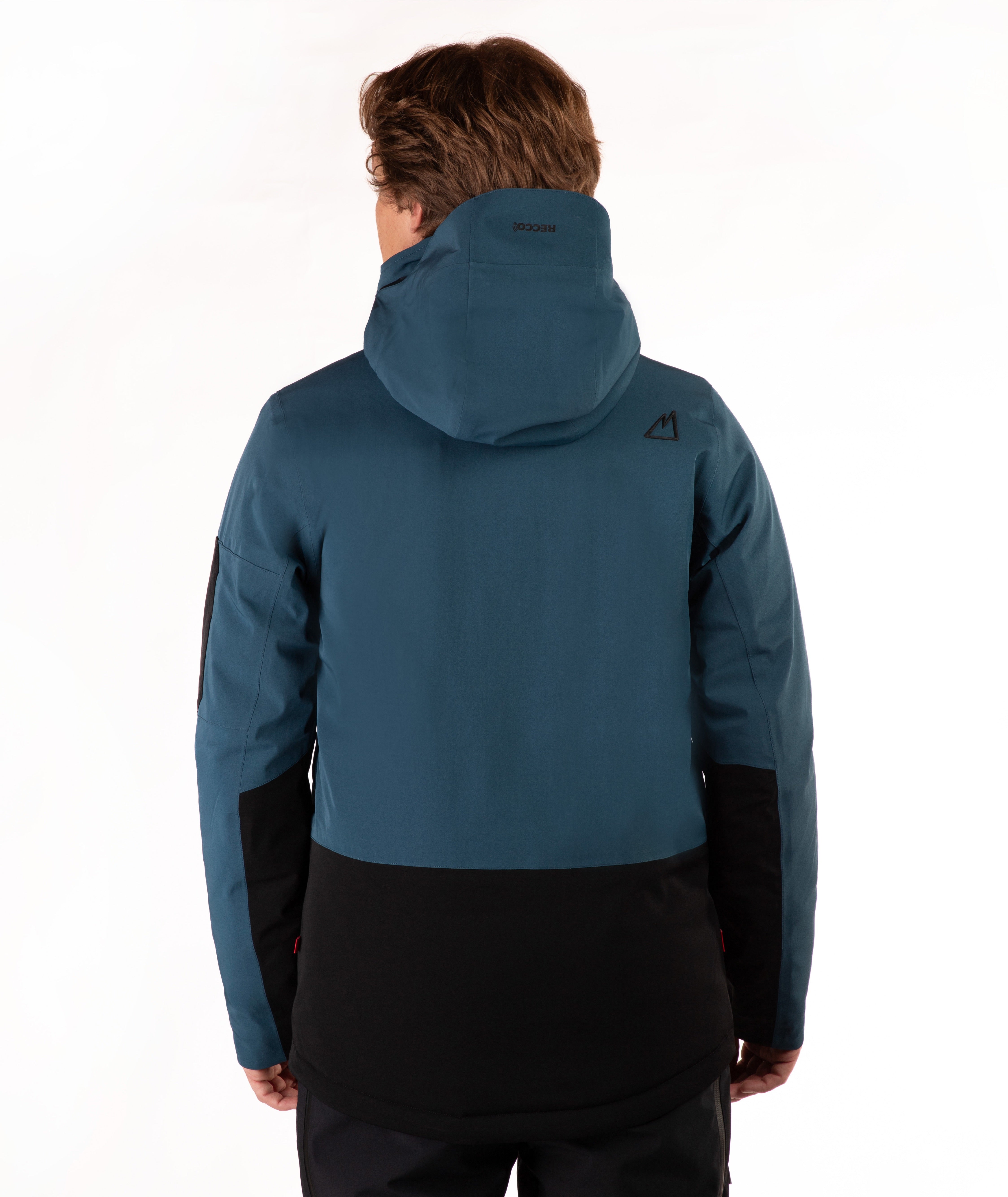 A man viewed from the back wearing a teal blue hooded ski jacket with black color blocking on the lower back and sleeves, set against a plain white studio background.