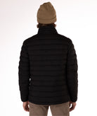 back of Man wearing a black puffer jacket on a white background