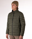 Man wearing a green puffer jacket on a white background