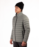 Man wearing a beige puffer jacket on a white background