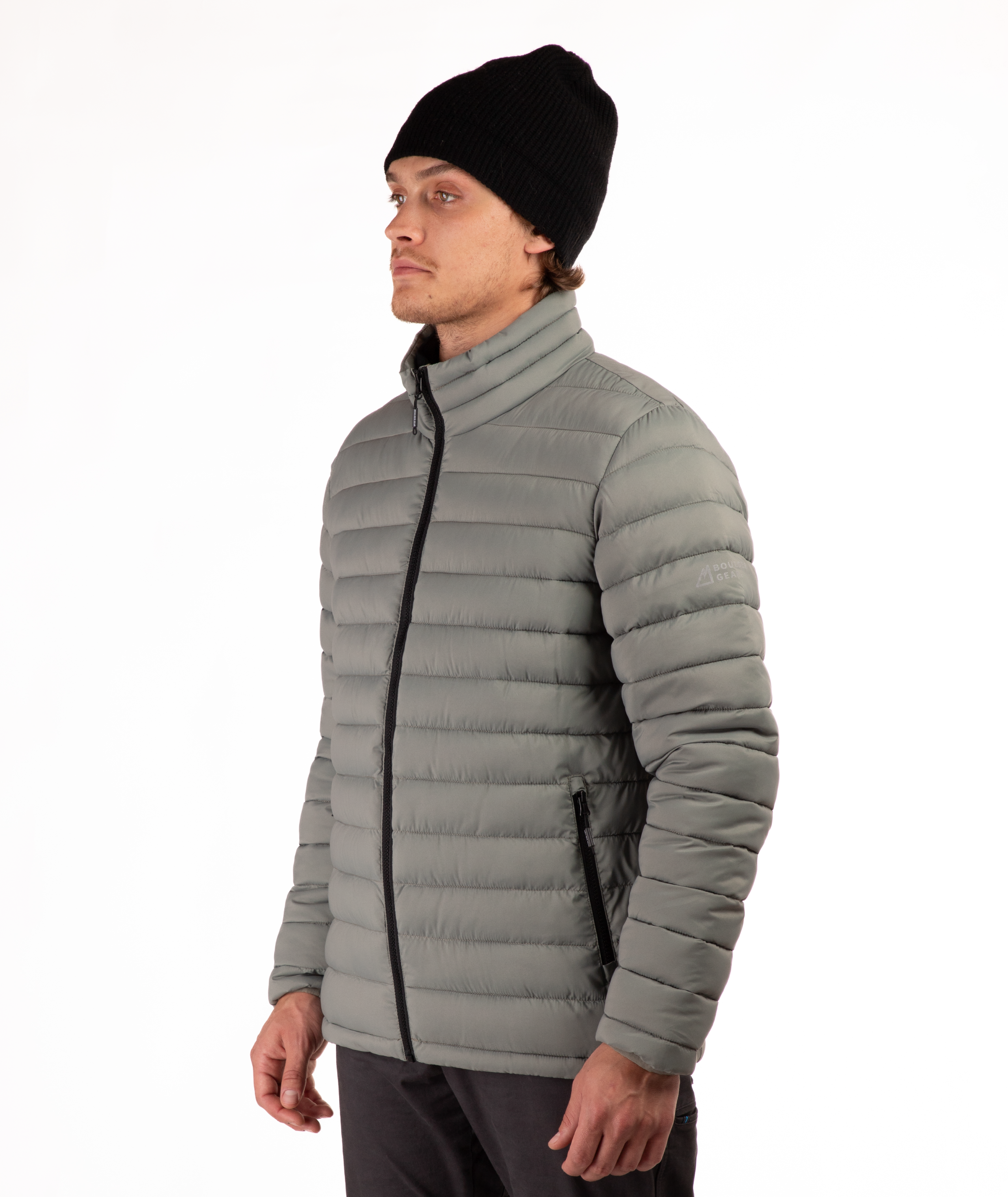 Man wearing a beige puffer jacket on a white background