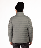 back of Man wearing a beige puffer jacket on a white background