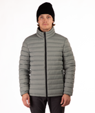 Man wearing a beige puffer jacket on a white background