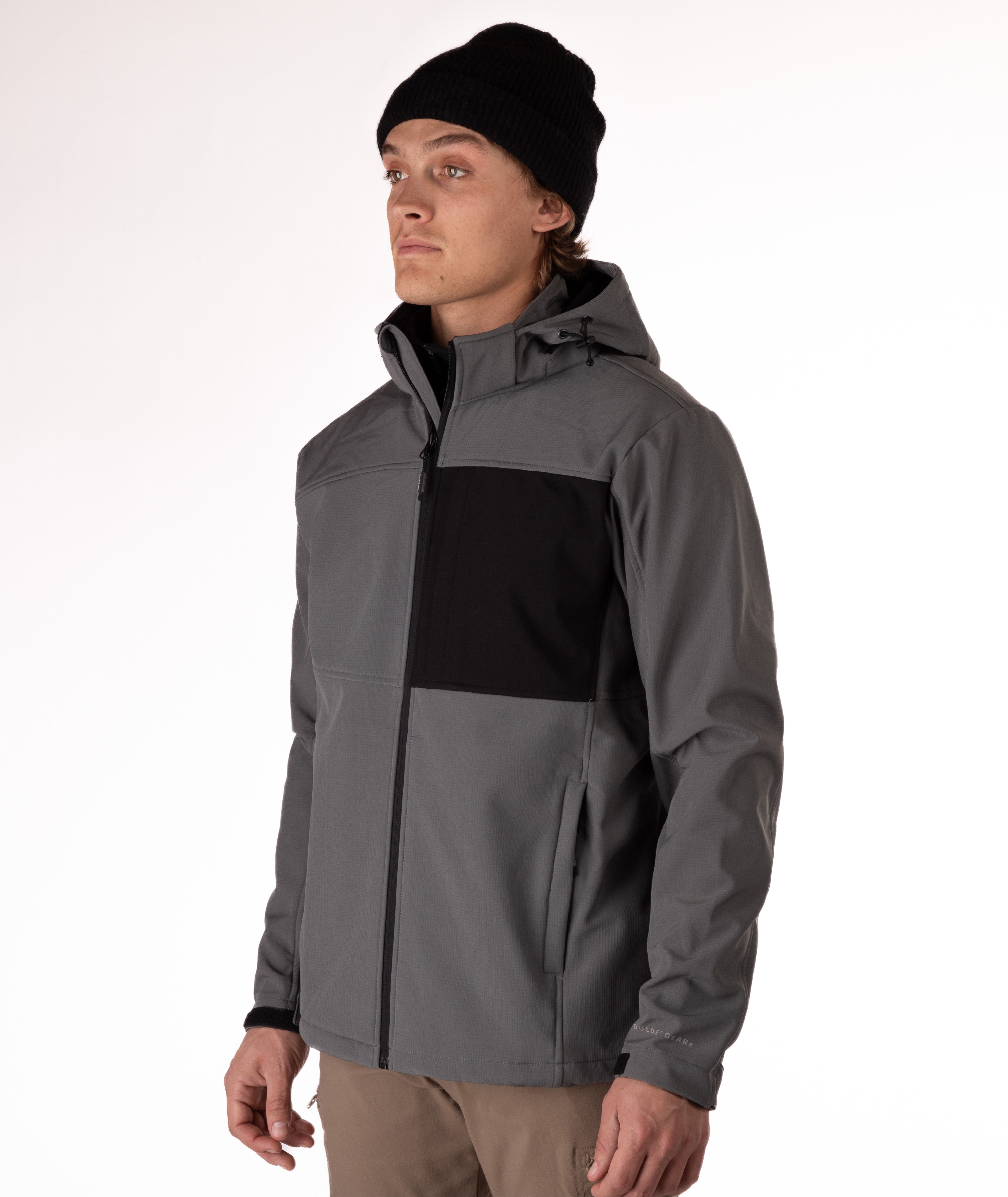 Man wearing a gray and black jacket with a white background