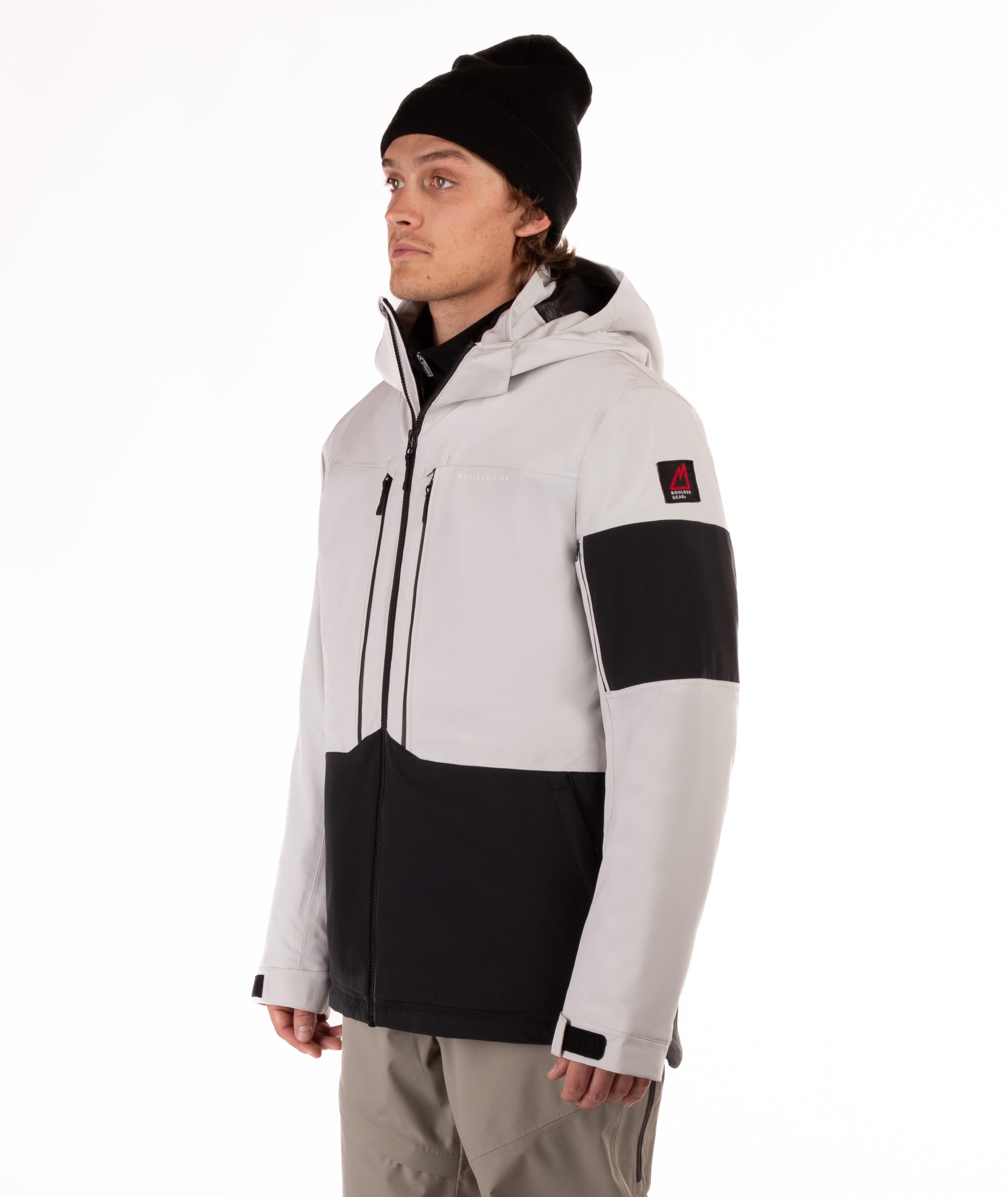 Person wearing a gray and black jacket with a white background