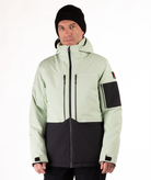 Man wearing a light green and black jacket on a white background