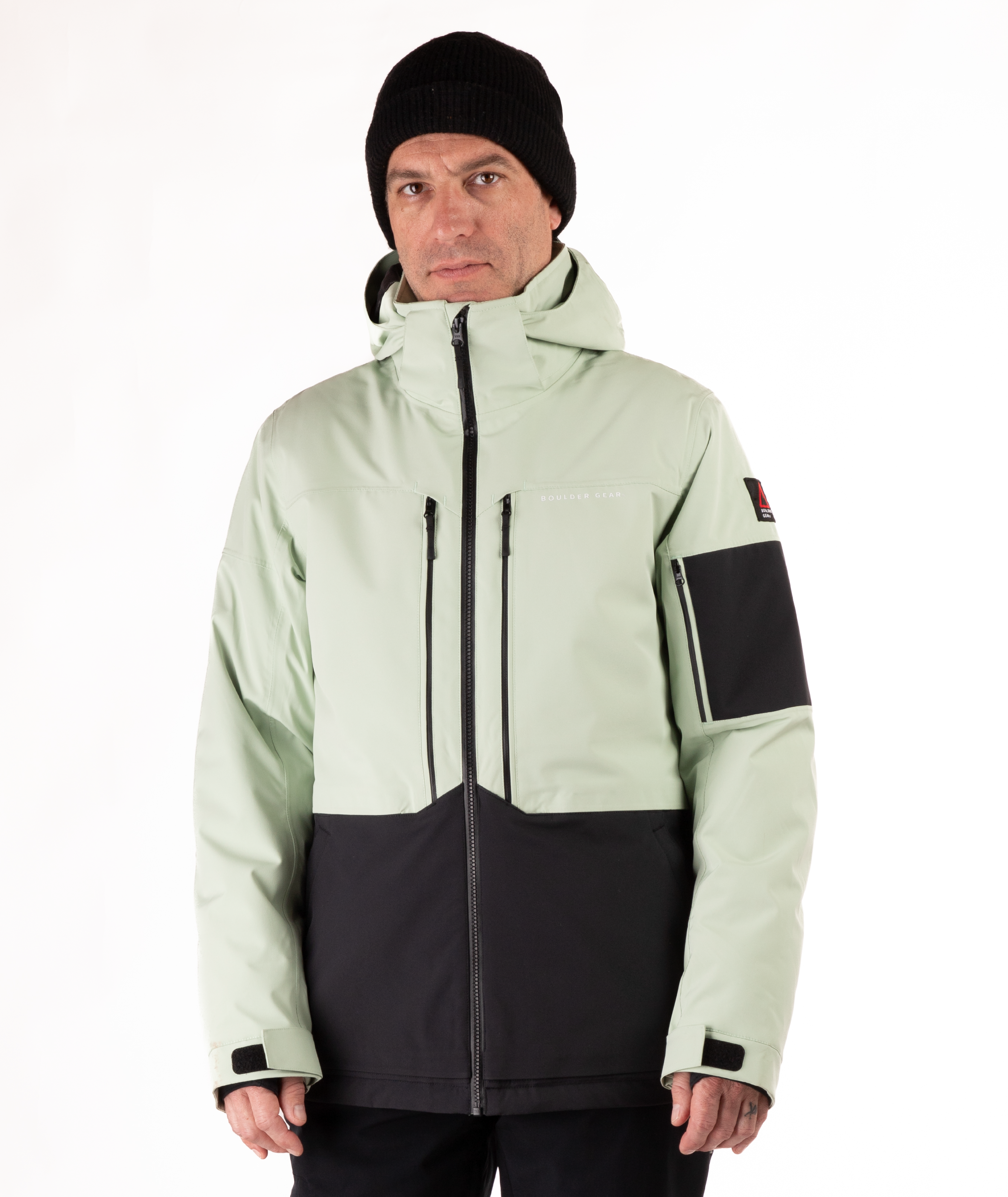 Man wearing a light green and black jacket on a white background