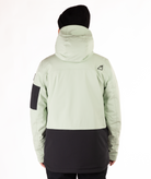 back of person wearing a light green and black jacket on a white background