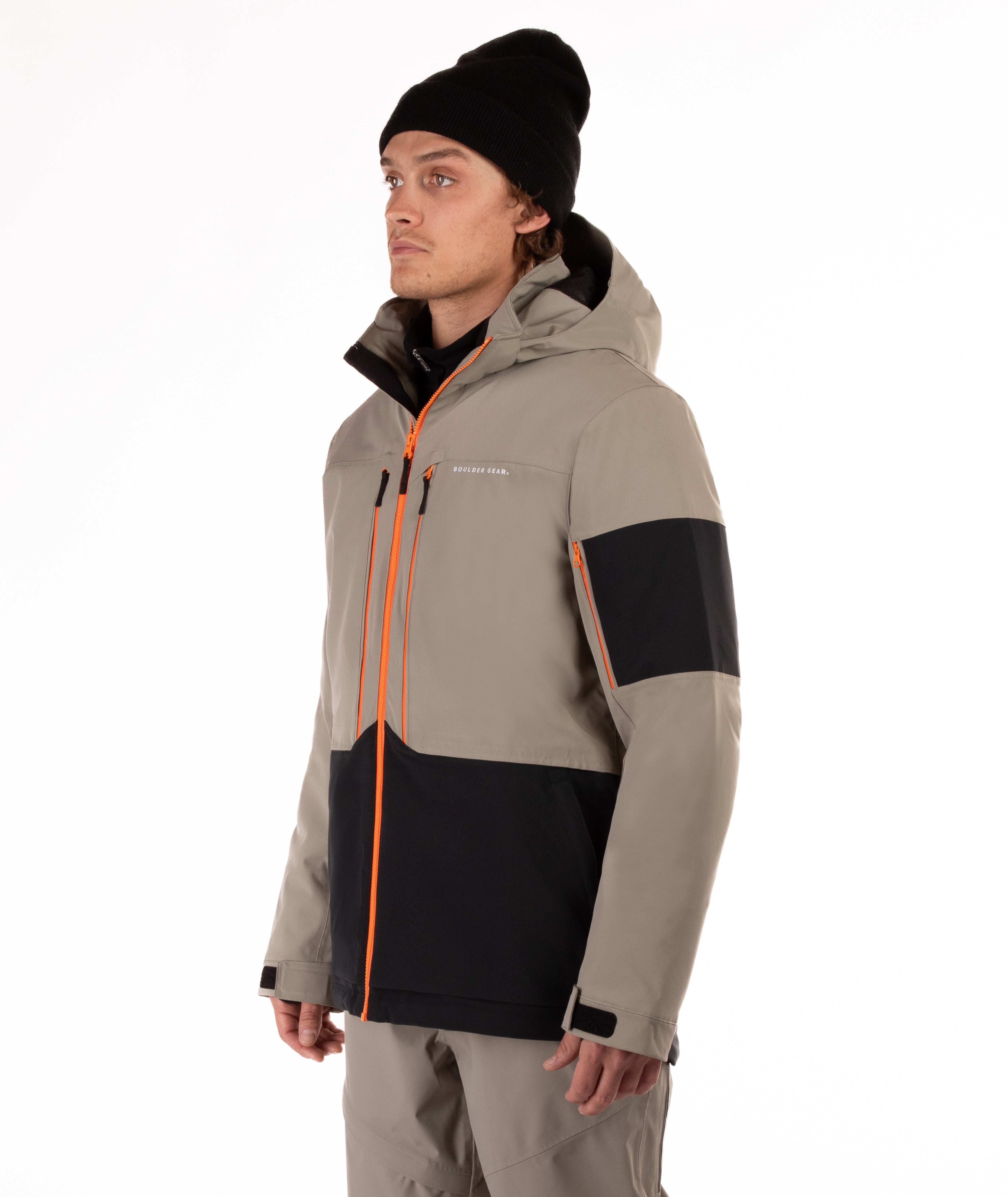 Man wearing a beige and black jacket with orange accents on a white background