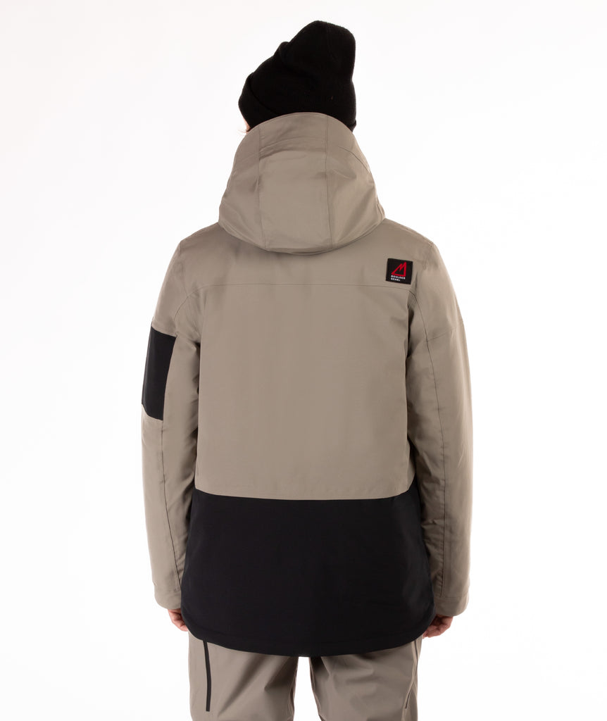 back of man wearing a beige and black jacket with hood on a white background