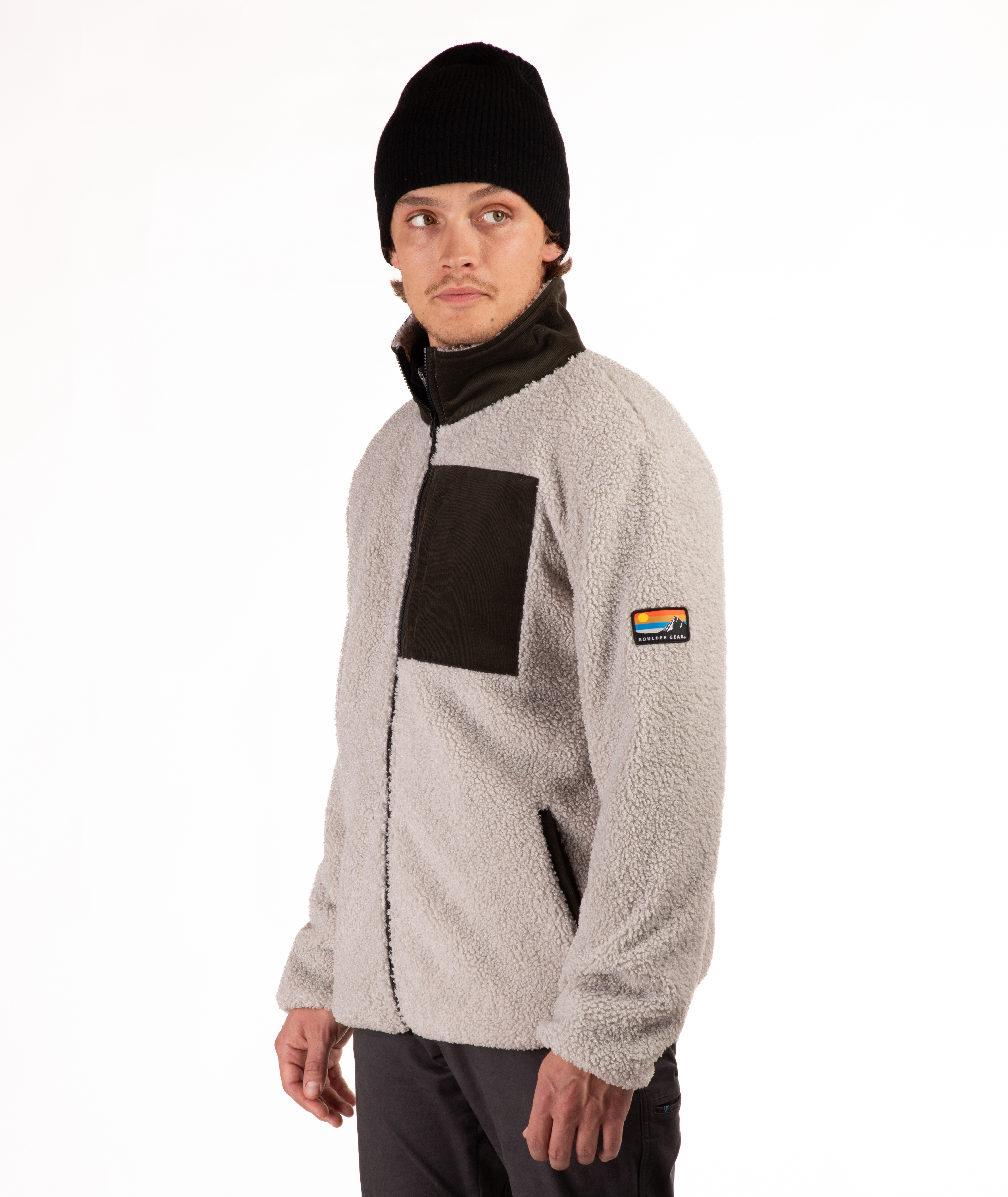 man wearing an light gray fleece jacket with green chest pocket and collar on white background