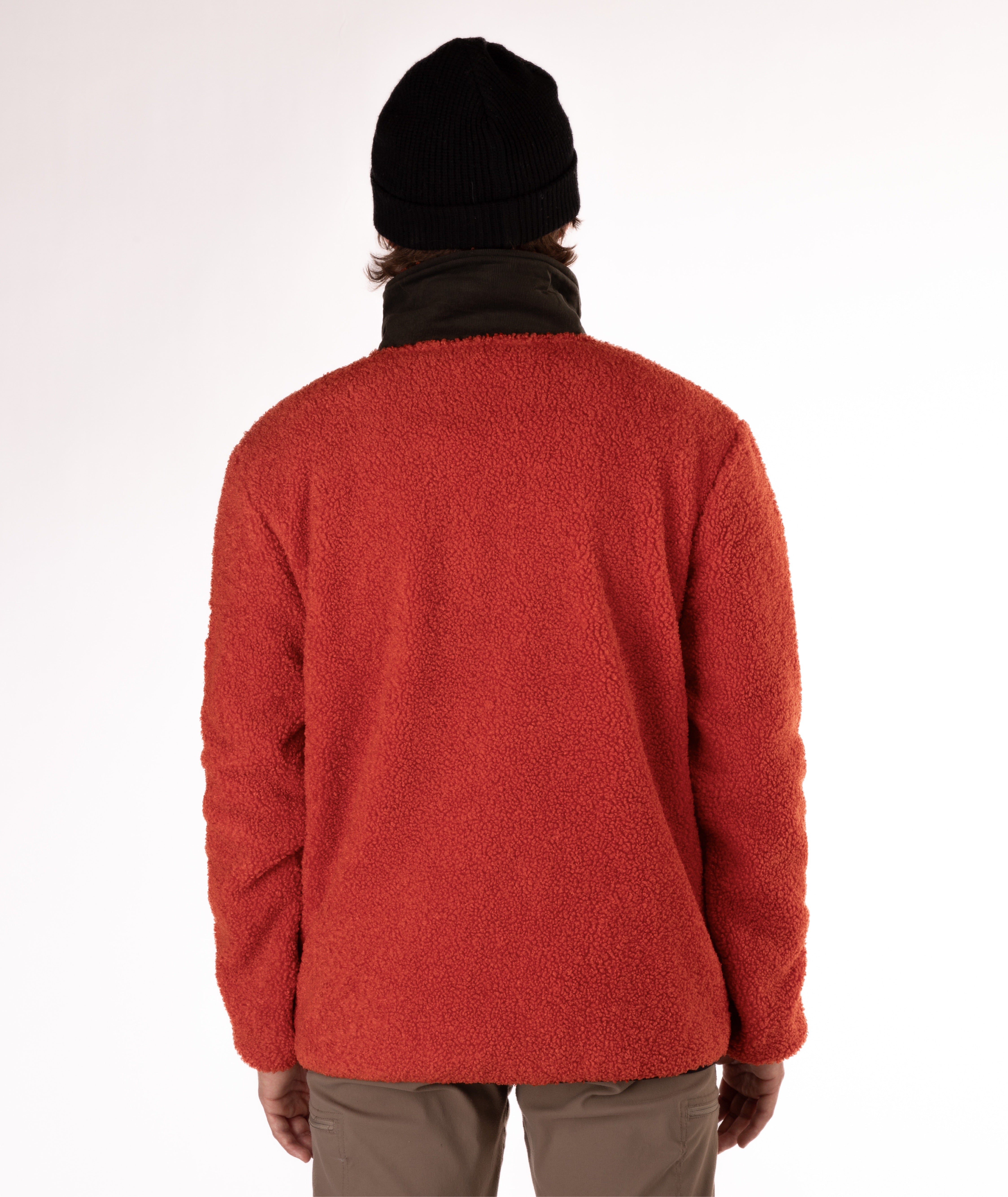 back of man wearing an orange fleece jacket with green collar on white background