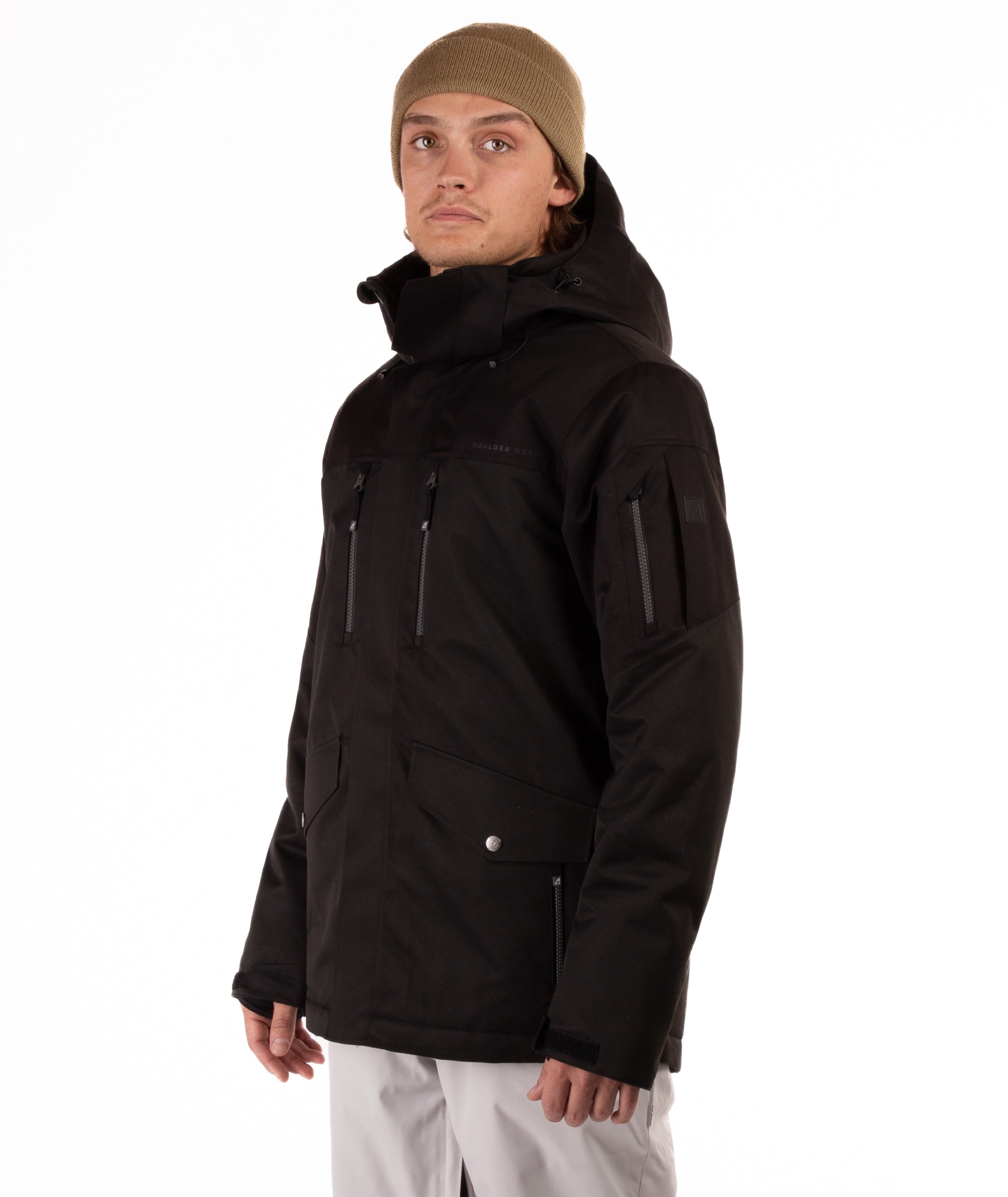 Person wearing a black jacket with chest pocket zippers on a white background