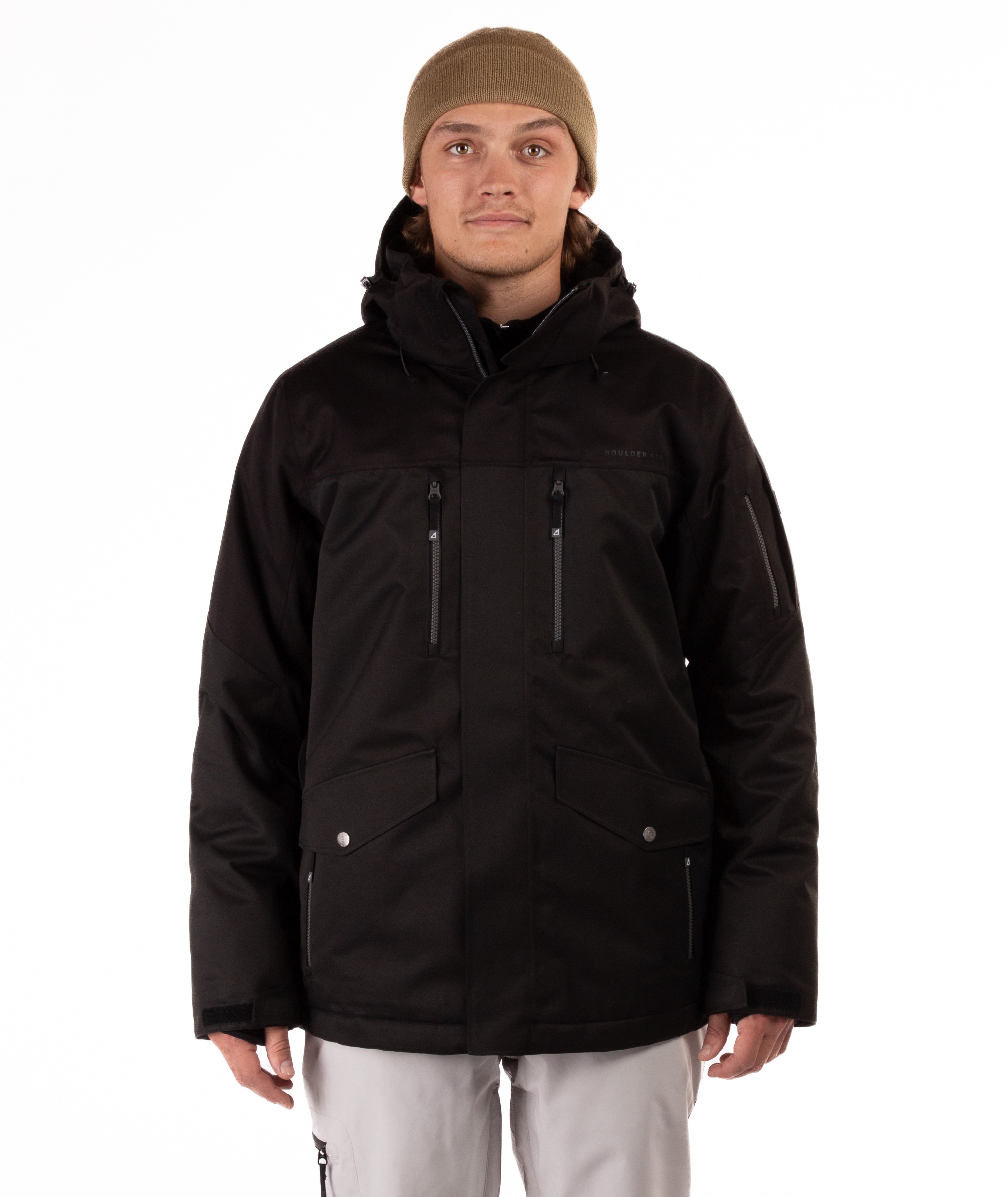 Person wearing a black jacket with chest pocket zippers on a white background