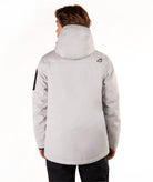 A person shown from the back wearing a light gray hooded jacket with a small black logo on the upper back and a black sleeve detail, photographed against a plain white studio background.