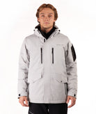 Man wearing a light gray jacket with black accents on a white background