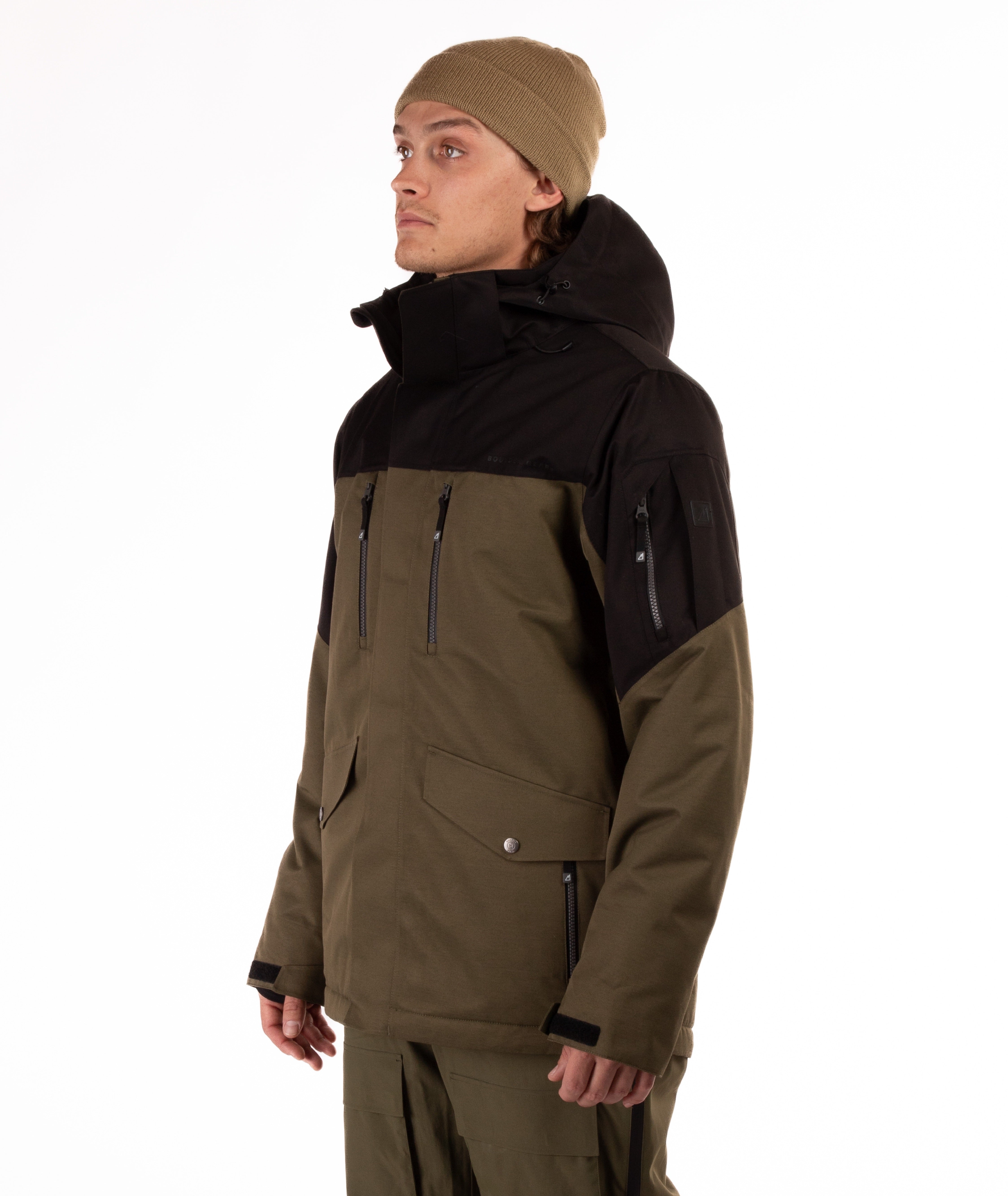 Man wearing a olive green and black jacket on a white background