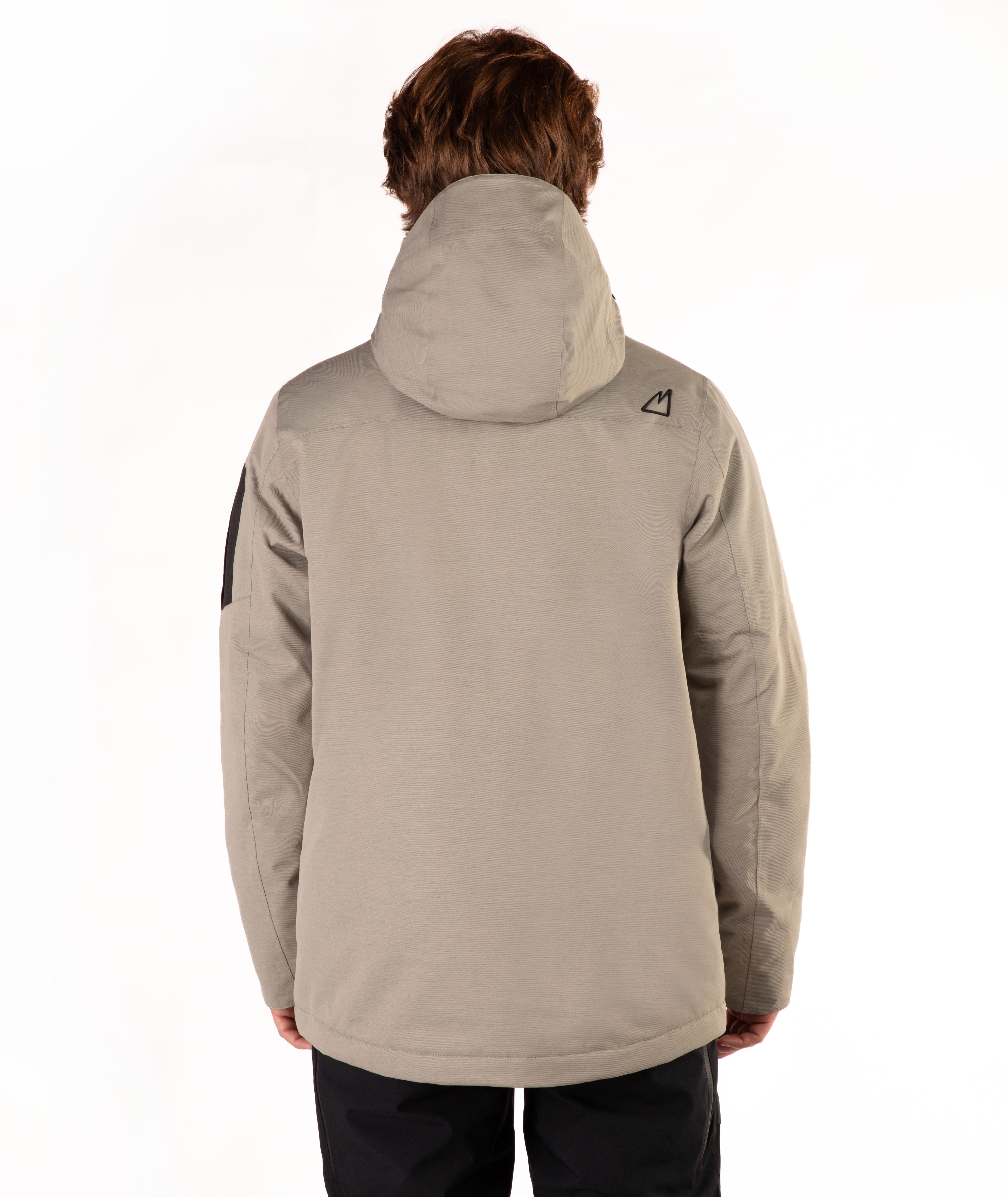 A person shown from the back wearing a light taupe hooded jacket and dark pants against a plain white studio background.