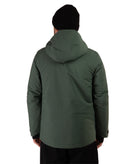 A man viewed from the back wearing an olive green hooded jacket and a black beanie against a plain white background.