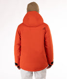 Man wearing a hooded orange jacket with a brand logo on a white background