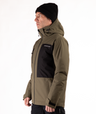 Person wearing a green and black jacket with a visible brand logo on a white background